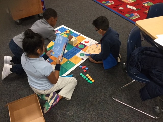 Students working with a codeable robot called Cubetto. Students working with a codeable robot called Cubetto.