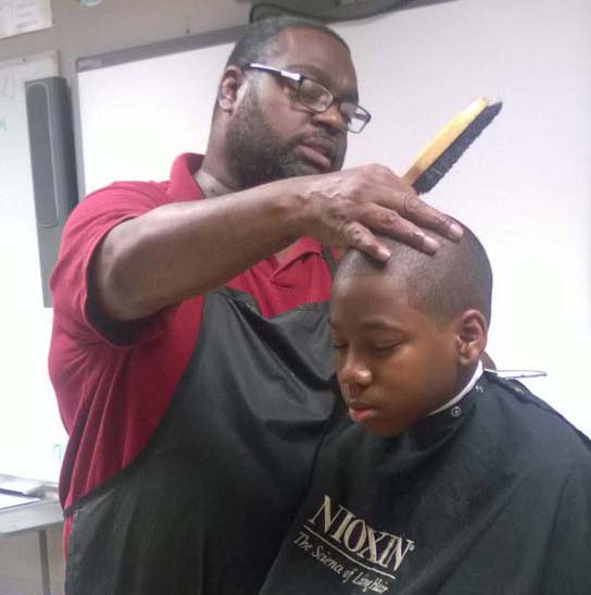 community volunteer cutting hair